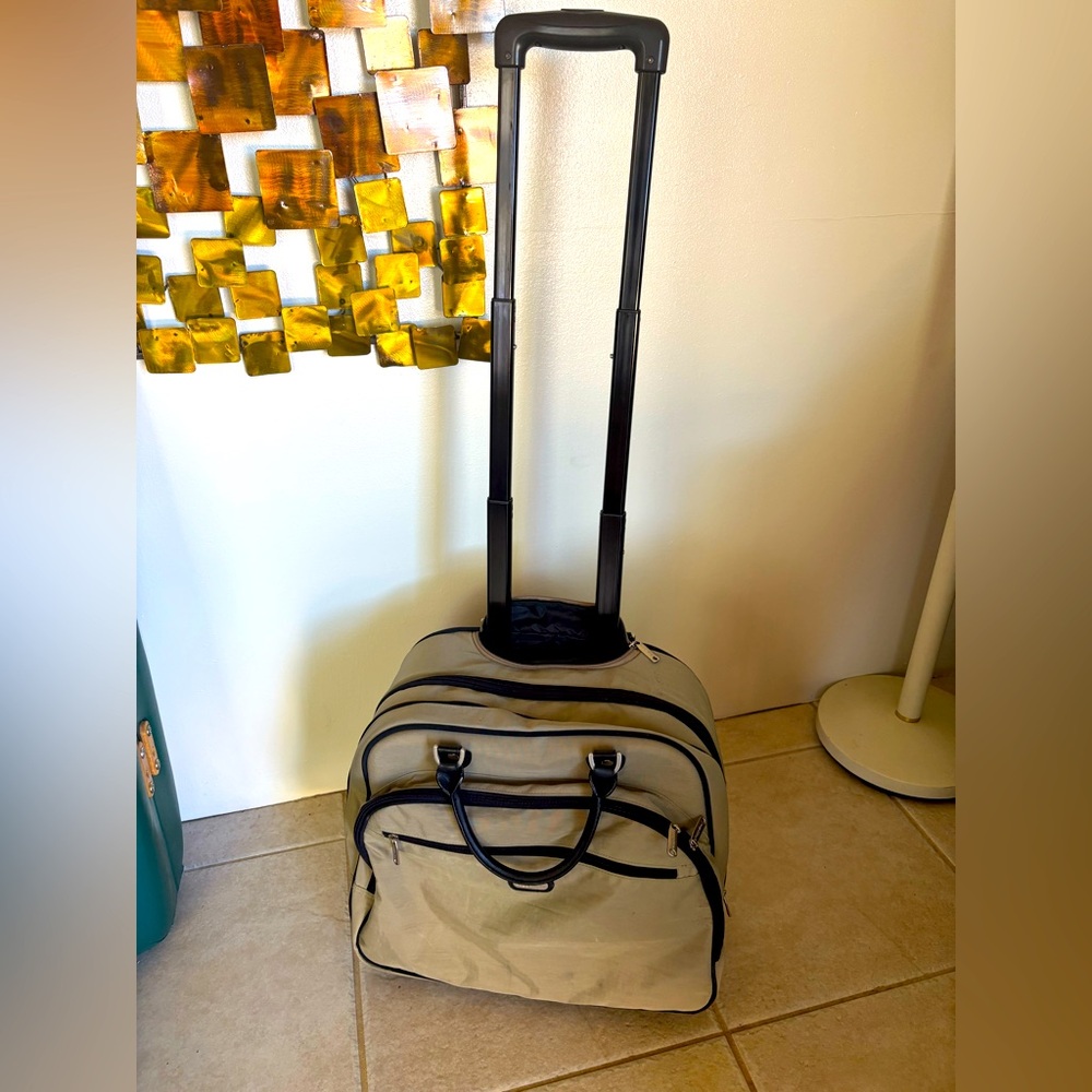 Baggallini Carry -On rolling bag with wheels and tall handle 20” by 18” by 12”